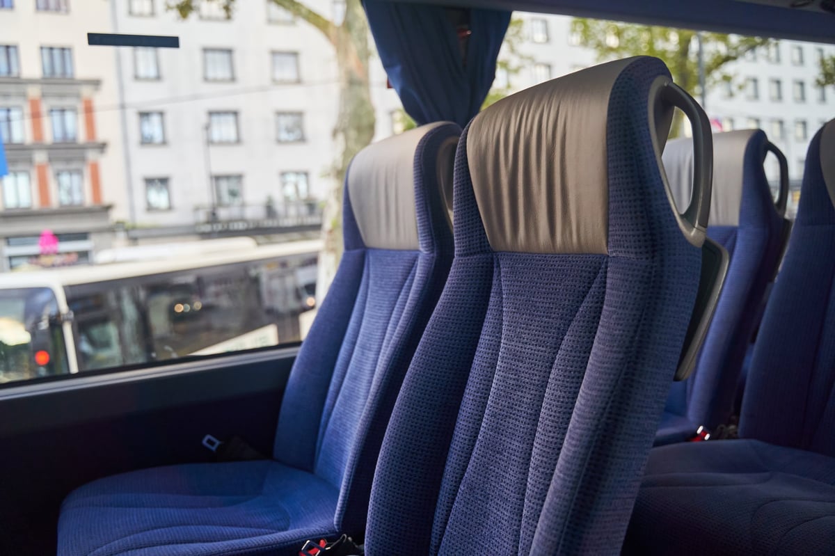 Blue bus seats with city view from the window